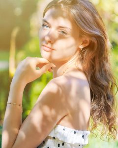 alt="Portrait Of Beautiful Young Woman Standing Outdoors"